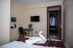 a swan made out of towels on a bed at ST Augustine Hotel Ltd in Kisumu
