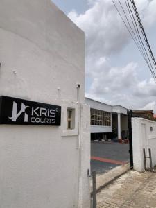 a building with a kris courts sign on the side of it at Kris Courts in Ibadan