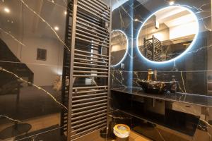 a bathroom with a sink and a mirror at La Bulle Prestige in Montargis