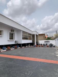 a large white building with a lot of windows at Kris Courts in Ibadan +13 photos