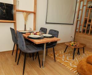 a dining room with a table and four chairs at La Bulle Prestige in Montargis +15 photos