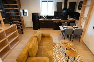 a living room with a couch and a table at La Bulle Prestige in Montargis