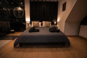 a bedroom with a large bed with pillows at La Bulle Prestige in Montargis