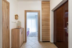 a hallway with a door leading to a room with a bedroom at Verde Mar Apartment in Tivat