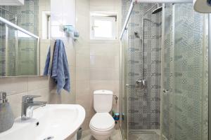 a bathroom with a toilet and a sink and a shower at Verde Mar Apartment in Tivat +3 photos
