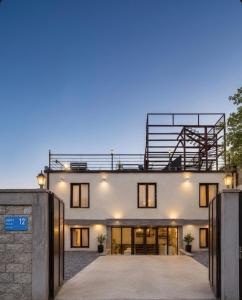 a large white building with a balcony on top of it at Hotel Blue sky in Tbilisi City