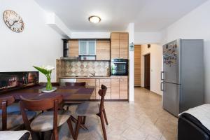 a kitchen with a table and chairs and a refrigerator at Verde Mar Apartment in Tivat