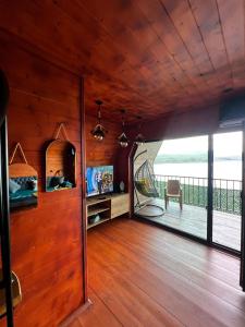a room with a wooden wall with a large window at Nakas cottage in Tbilisi City