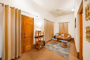 a living room with a chair and a table at Adviga by The StayCationer in Dehradun
