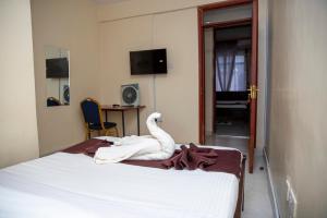 a swan statue sitting on top of a bed at ST Augustine Hotel Ltd in Kisumu