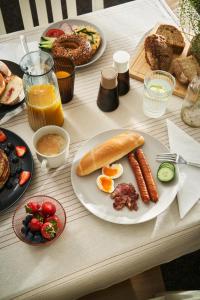 a table with a plate of breakfast food on it at Hotel Popel in Stachy +14 photos