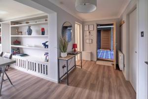 a living room with white shelves and a table at Finest Retreats - Gleneagles in Auchterarder