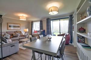 a living room with a table and a couch at Finest Retreats - Gleneagles in Auchterarder