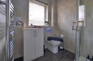 a bathroom with a toilet and a sink and a shower at Finest Retreats - Gleneagles in Auchterarder +17 photos