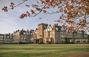 a large building with a flag on top of it at Finest Retreats - Gleneagles in Auchterarder