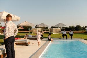 a group of people standing around a swimming pool at Rusiborek Slow in Murzynowo Kościelne