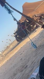 a boat sitting in the sand in the desert at Traditional nomad camp in Merdani