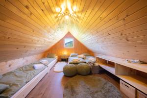 a room with two beds in a wooden cabin at Hiška Janko in Bohinjska Bistrica