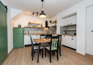 a kitchen with a table and chairs in a room at Seafront Stone House Maxim in Tivat
