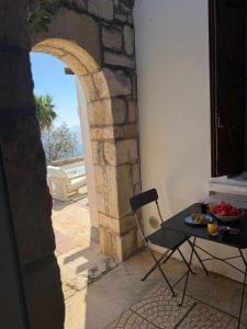 a table and a chair with a bowl of fruit on it at Zen Townhouse - Infinity Seaview in Palaiokastro