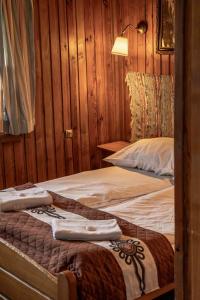 a bedroom with two beds with towels on them at Willa Orla in Zakopane