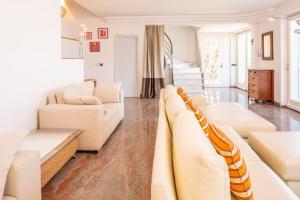a living room with white furniture and a couch at Villa Incanto Adults Only in Brenzone sul Garda +37 photos