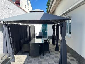 a blue umbrella on a patio with a table and chairs at Ferienwohnung Krause in Augsburg