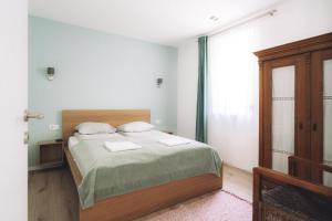 a bedroom with a bed with two towels on it at Katáng Vendégház in Tardosbánya +22 photos