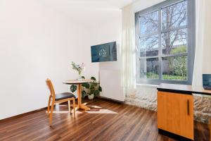 a living room with a table and a window at historic Apart in Erlangen