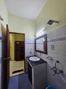 a bathroom with a sink and a mirror at PTC Residency in Alleppey +36 photos