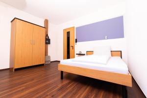 a bedroom with a bed and a cabinet at historic Apart in Erlangen