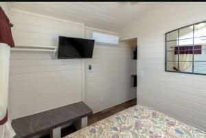 a small room with a tv and a bench at 49er Village in Plymouth