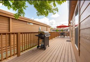 a grill on a wooden deck next to a fence at 49er Village in Plymouth