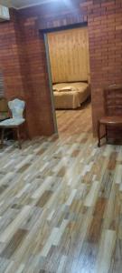 a room with a bed and a wooden floor at Dogurashi Turbaza in Tsʼageri