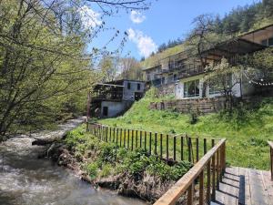 a house on a hill next to a river at Riviera Guesthouse in Dilijan