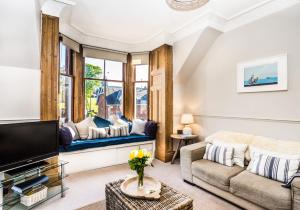 a living room with a couch and a tv at The Neuk in North Berwick