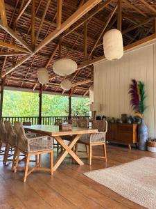 a dining room with a wooden table and chairs at The Angkayo in Angkayo