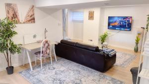 a living room with a couch and a table at Applewood Gardens Apartment in Mississauga