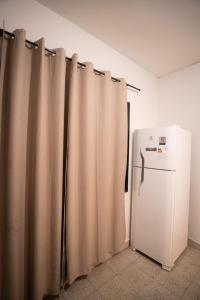 a refrigerator in a room with curtains around it at Boutique 1970 Hotel in Asunción