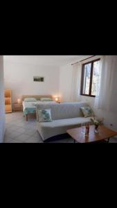a living room with a couch and a table at podskoj apartment in Saplunara
