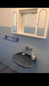 a bathroom with a sink and a medicine cabinet at podskoj apartment in Saplunara