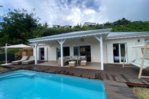 a villa with a swimming pool and a house at Villa Duna 2 Bedrooms Pool & Tropical Atmosphere in Sainte-Anne