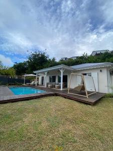 a house with a swimming pool in the yard at Villa Duna 2 Bedrooms Pool & Tropical Atmosphere in Sainte-Anne +41 photos