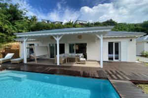 a villa with a swimming pool and a house at Villa Duna 2 Bedrooms Pool & Tropical Atmosphere in Sainte-Anne
