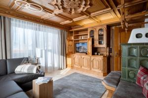 a living room with a couch and a tv at Walcherbäck in Fieberbrunn