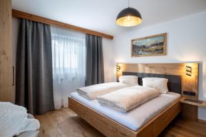 a bedroom with a bed and a large window at Walcherbäck in Fieberbrunn