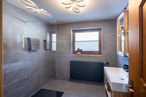 a bathroom with a shower and a sink and a window at Walcherbäck in Fieberbrunn +8 photos