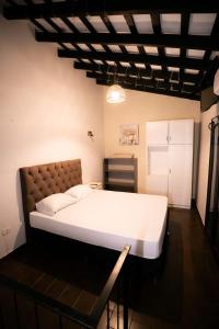 a bedroom with a large white bed in a room at Boutique 1970 Hotel in Asunción