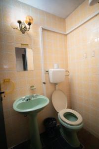 a bathroom with a toilet and a sink at Boutique 1970 Hotel in Asunción +20 photos