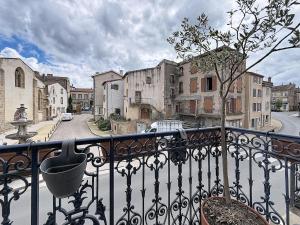 a view of a city from a balcony with a tree at Maison de bourg - Charmante & Authentique , PLAUZAT in Plauzat